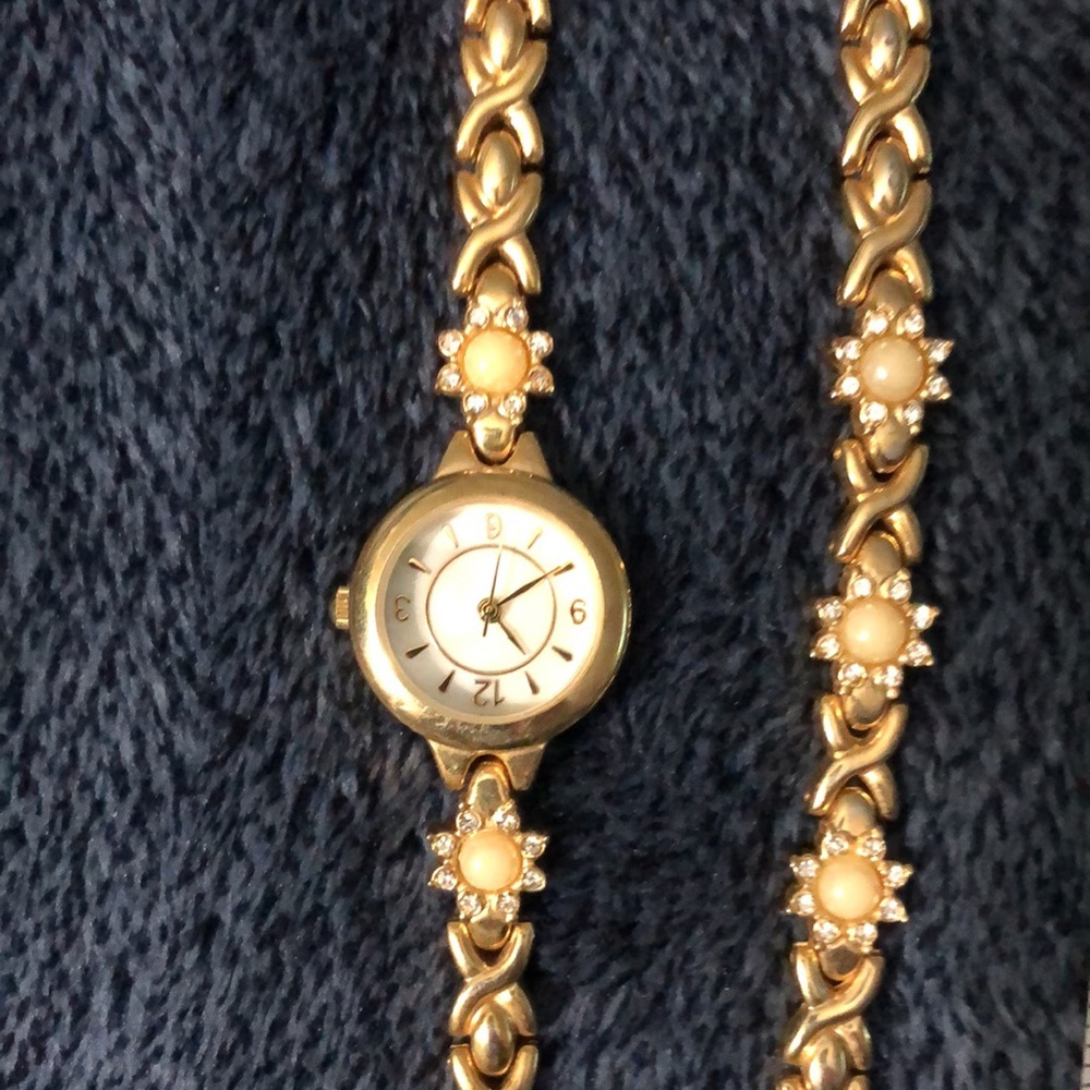Gold toned watch with latch